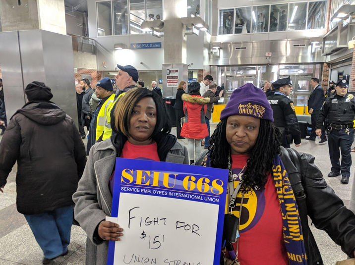 Home healthcare workers Stephanie Williams, (left), and Lolita Owens rally at the Frankford Transportation Center in February to pressure state lawmakers to increase the state minimum wage to $15 an hour. (Michael D’Onofrio/The Philadelphia Tribune)