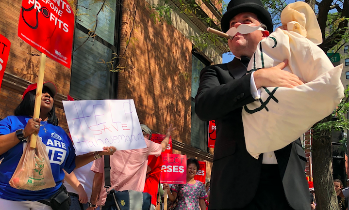 Hospital workers gathered Friday morning outside Hahnemann owner Joel freedman’s Rittenhouse apartment building to demand he keep the hospital open (Nina Feldman/WHYY)