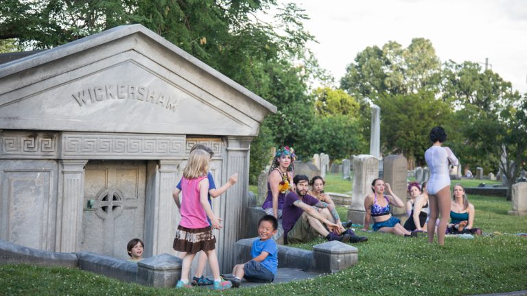 Kids and aerialists play side by side in the Woodlands cemetery. (Emily Cohen for WHYY)