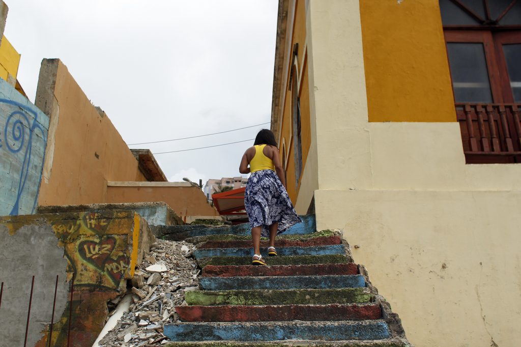 A woman walks through La Perla, a neighborhood on the edge of Old San Juan, in 2017. A woman walks through La Perla, a neighborhood on the edge of Old San Juan, in 2017. (AFP Contributor/Getty Images)