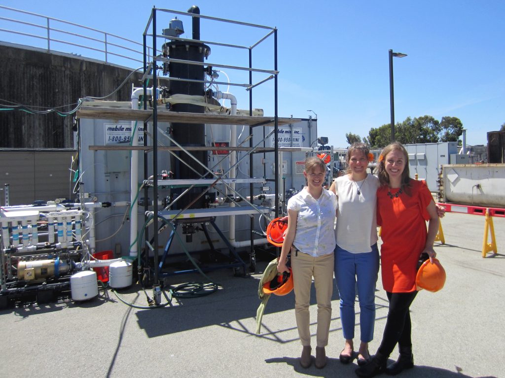 Anne Schauer-Gimenez (from left) Allison Pieja and Molly Morse of Mango Materials stand next to the biopolymer fermenter at a sewage treatment plant next to San Francisco Bay. The fermenter feeds bacteria the methane they need to produce a biological form of plastic. Anne Schauer-Gimenez (from left) Allison Pieja and Molly Morse of Mango Materials stand next to the biopolymer fermenter at a sewage treatment plant next to San Francisco Bay. The fermenter feeds bacteria the methane they need to produce a biological form of plastic. (Chris Joyce/NPR)