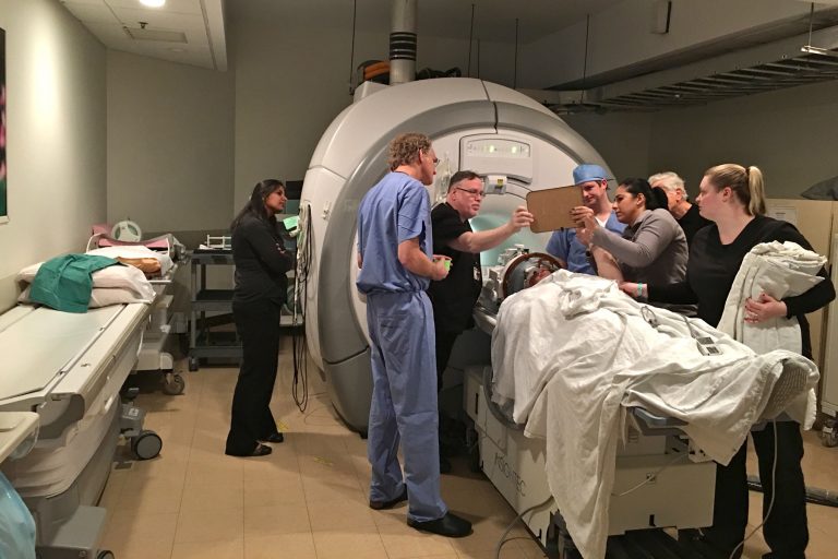 2017-12-14-k-greenberg-gordon-baltuch-james-neyhart-philadelphia-pennsylvania-hospital-tremor-ultrasound-lead-768×512 Dr. Gordon Baltuch and his team check on a patient throughout a procedure that uses a beam of ultrasound waves to stop his hand from trembling. (Kyrie Greenberg/WHYY)