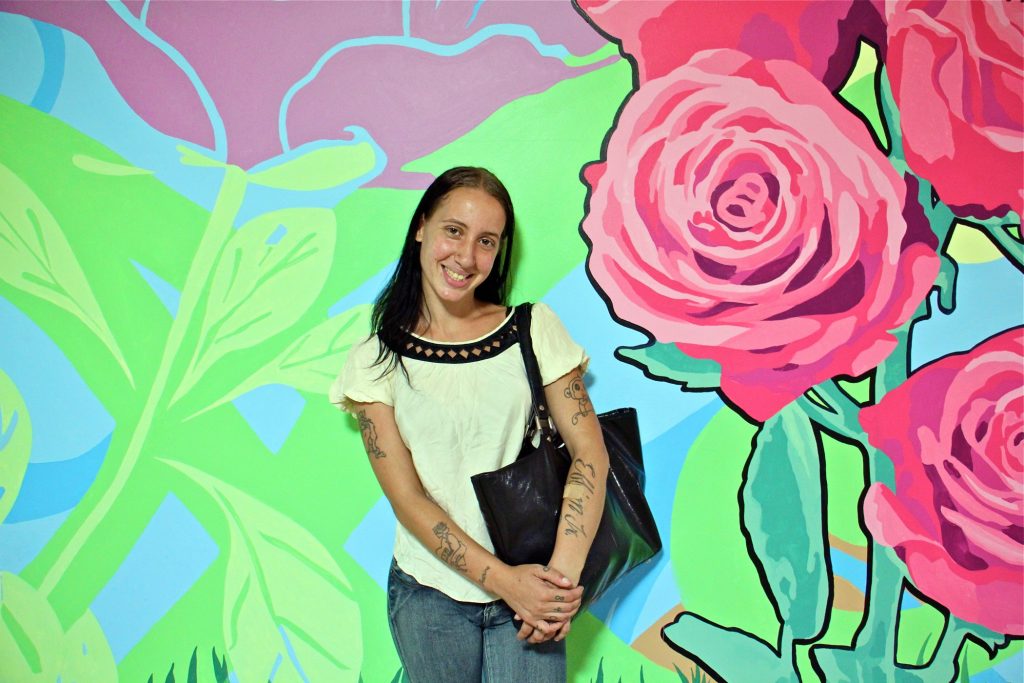 2019 07 30-e lee-becky green-philadelphia suburban station-mural Becky Green, 27, stands in front of the mural she helped to create in SEPTA Suburban Station. (Emma Lee/WHYY)