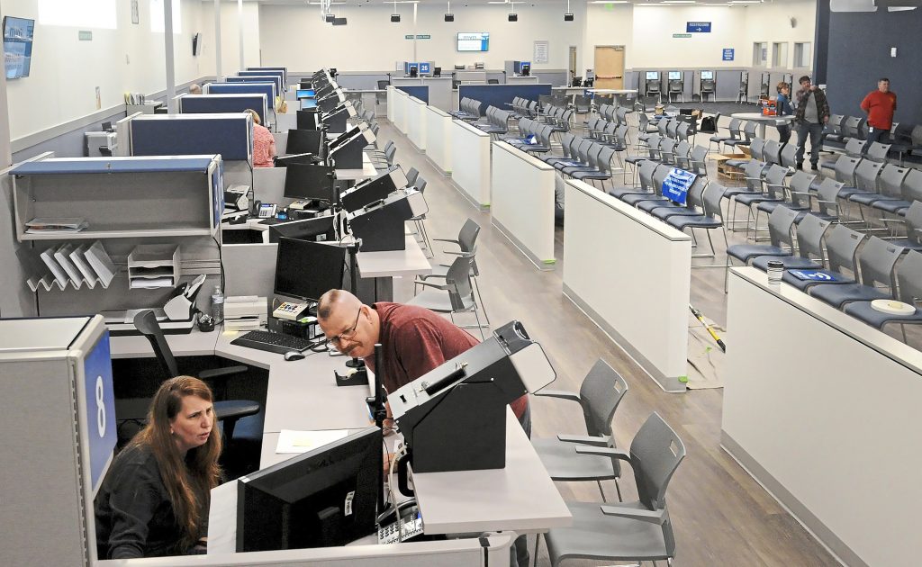 PennDOT Driver’s License Real ID Center In this Wednesday, Feb. 27, 2019 photo, Acting supervisor Lisa Reeder, left, and supervisor Kevin Keylor of PennDOT Driver's License/Real ID Center run a system test on computers in Bridgeville, Pennsylvania. (Lake Fong/Pittsburgh Post-Gazette via AP)