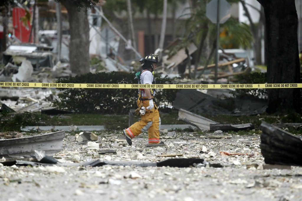APTOPIX Shopping Center Plaza Explosion A firefighter walks through the remains of a building after an explosion on Saturday, July 6, 2019, in Plantation, Fla. Several people were injured after a vacant pizza restaurant exploded in the South Florida shopping plaza Saturday, according to police. The restaurant was destroyed, and nearby businesses were damaged. (Brynn Anderson/AP Photo)