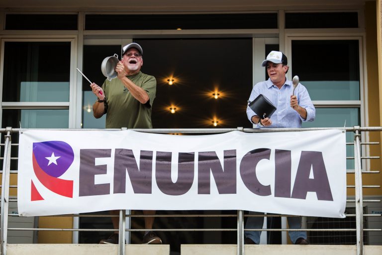 Demonstrators bang on pots, from the balcony of their apartment as they protest against governor Ricardo Rossello, in San Juan, Puerto Rico, Friday, July 19, 2019. (Dennis M. Rivera Pichardoi/AP Photo)