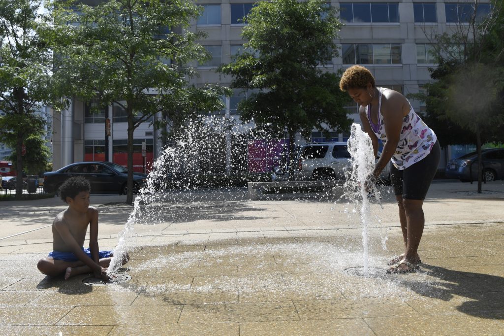 Karen Frazier, Amari Rogers Karen Frazier of Capitol Heights, Md., right, and her son Amari Rogers, 11, left, play in a fountain in Washington, Saturday, July 20, 2019. The National Weather Service said