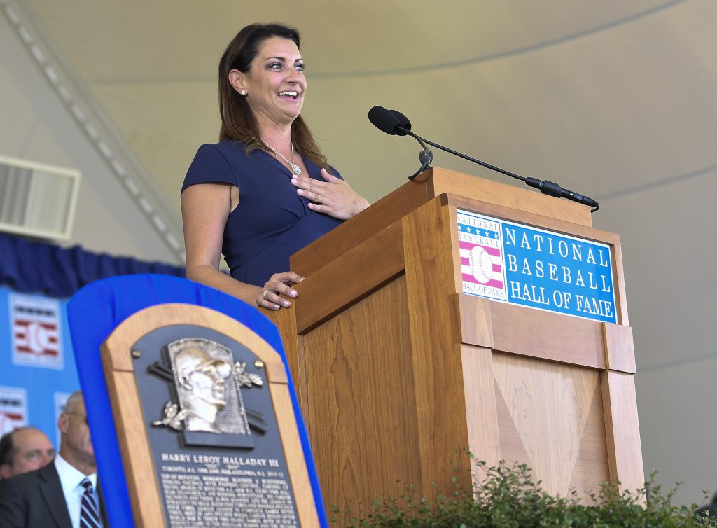 CORRECTION Hall of Fame Inductions Baseball Brandy Halladay, widow of Roy Halladay, speaks as he is inducted posthumously into the National Baseball Hall of Fame during an induction ceremony at the Clark Sports Center on Sunday, July 21, 2019, in Cooperstown, N.Y. (Hans Pennink/AP Photo)