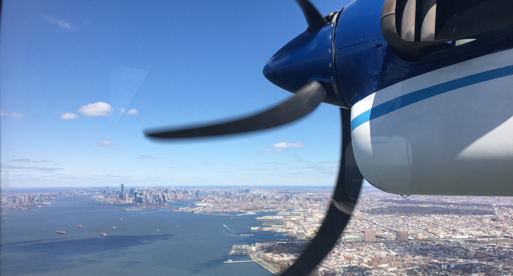 AP_19203707301404 In this 2018 photo, a Twin Otter aircraft flies over New York Harbor and New York City on a research mission. In older Eastern US cities, nine times as much natural gas is leaking out of pipelines, homes than federal government had thought. (Eric Kort/University of Michigan via AP)