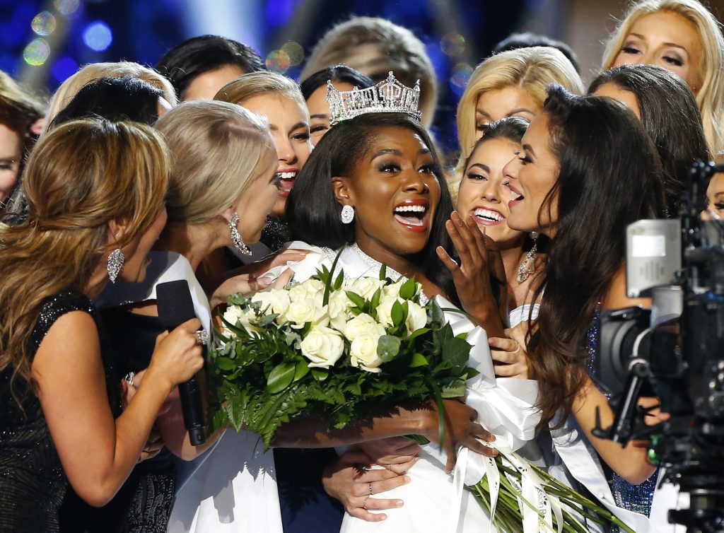 Miss America-Relocation FILE - This Sept. 9, 2018 file photo shows Miss New York Nia Franklin, center, reacting after being named Miss America 2019 in Atlantic City, N.J. The Miss America Organization says this year's pageant will be held at the Mohegan Sun Connecticut in Uncasville, Connecticut. It will be broadcast on NBC Dec. 19, in a switch from recent broadcaster ABC. (AP Photo/Noah K. Murray, File)