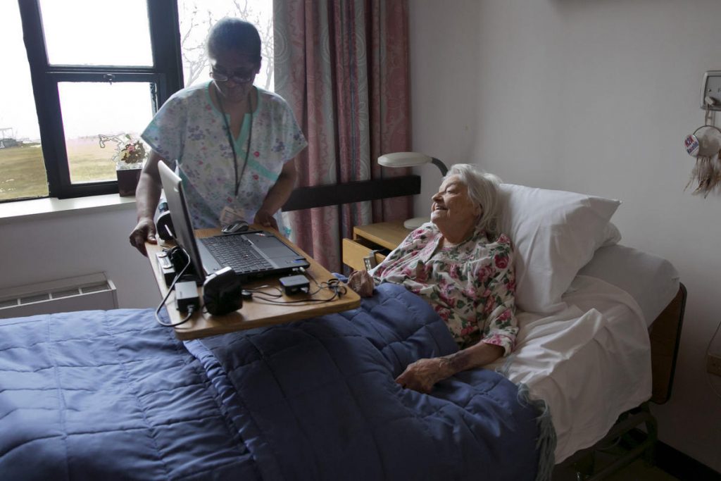 Louise Irving, Noemi Ford A nurse's aide helps nursing home patient Louise Irving on Wednesday, March 25, 2015. (Richard Drew/AP Photo)