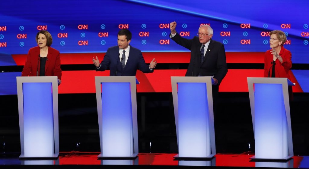 Election 2020 Debate Sen. Amy Klobuchar, D-Minn., from left, South Bend Mayor Pete Buttigieg, Sen. Bernie Sanders, I-Vt., and Sen. Elizabeth Warren, D-Mass., participate in the first of two Democratic presidential primary debates hosted by CNN Tuesday, July 30, 2019, in the Fox Theatre in Detroit. (AP Photo/Paul Sancya)