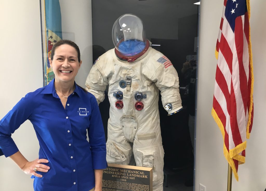 Patty Stoll, senior director and division manager for ILC Dover’s space systems division, stands with a suit made at ILC Dover in Frederica, Delaware for the Apollo mission. (Mark Eichmann/WHYY)