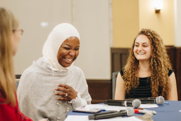 Conversationalists Kameelah Mu'Min Rashad and Emily Zislis share a laugh with WHYY’s Jennifer Lynn during A Conversation on Identity and Belonging hosted at the University of Pennsylvania. (Riley Jackson/Interfaith Philadelphia)