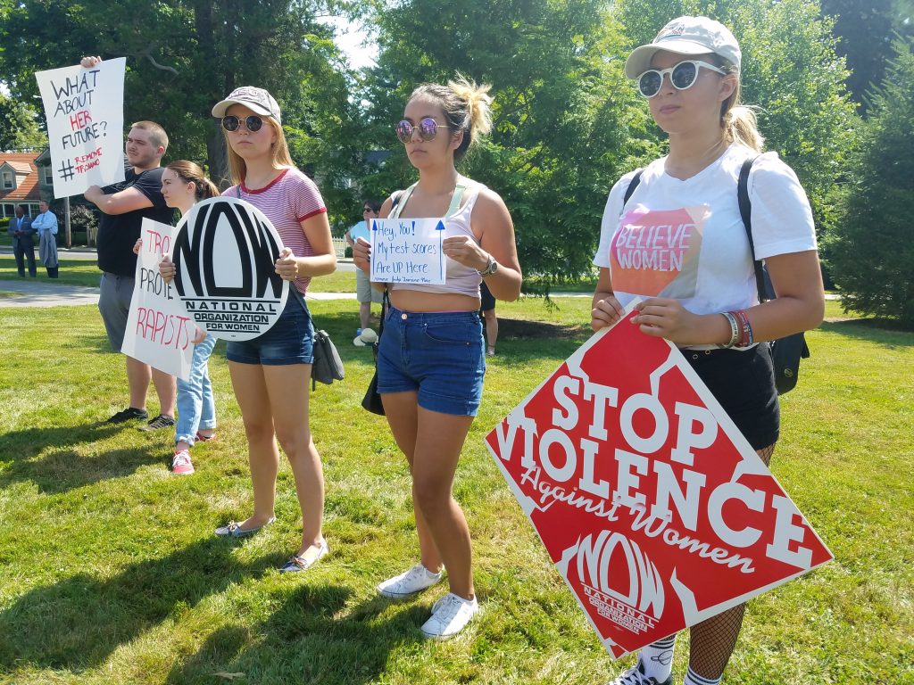 Judge3 (From left) Friends Olivia Corveleyn, Sienna Bucu and Abby Hagen, all of Union, at a protest in Freehold to demand the removal of Judges Troiano and Silva on July 11, 2019. (Nicholas Pugliese/WHYY)