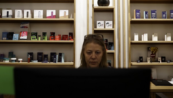 Salesperson Cheri McFarland works on a sales computer in front of displayed marijuana products at Beyond/Hello, Center City Philadelphia's first medical marijuana dispensary on Jan. 24, 2019. (Matt Slocum/AP Photo)
