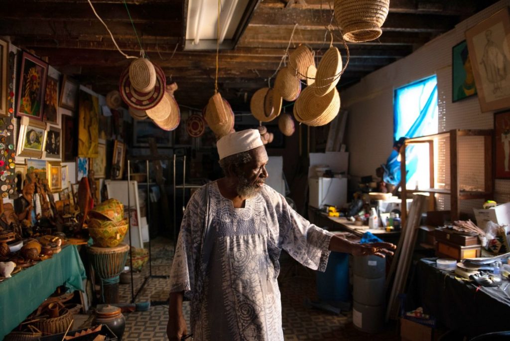 Philadelphia_52ndStCorridor_ACAF_1400_935_80 Sharif Abdur-Rahim, one of two founding brothers of West Philadelphia's African Cultural Arts Forum, stands in a second-floor workshop used to store African art and to produce the oils, incense and personal-care products they sell. (Kriston Jae Bethel for NextCity)