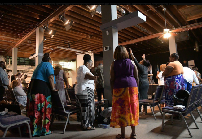 Church members at Truth Church Worship Center praise during Sunday service held at Masters Builders Church in Northeast Philadelphia. A power outage in Overbrook Park where they normally praise caused the congregation to find a temporary place to worship on June 30 (Marissa Weekes Mason/The Philadelphia Tribune)