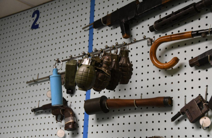 Inactive grenades hang on the wall in the gun archive in the Philadelphia Police Department's Forensic Science Center. (Abdul Sulayman/The Philadelphia Tribune)