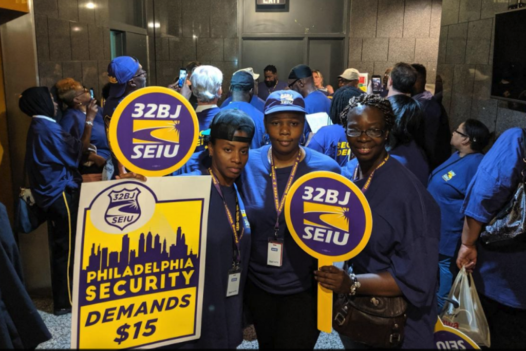 Screen Shot 2019-07-23 at 11.19.31 AM SEIU union members rally inside the first floor of the Municipal Service Building to file a complaint against universities and hospitals, and a contractor for them who the union claims is not paying security workers the prevailing wage on Monday. (Michael D'Onofrio/The Philadelphia Tribune)
