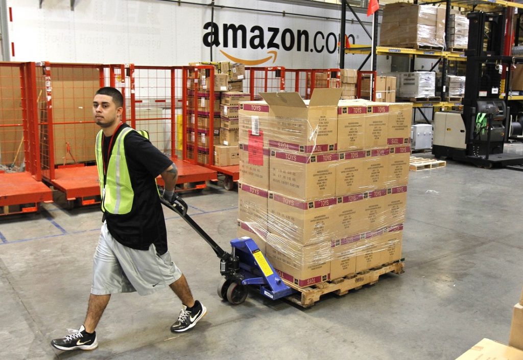 Humberto Manzano, Jr. Humberto Manzano, Jr., delivers an arriving pallet of goods at an Amazon.com fulfillment center in Phoenix. (AP Photo/Ross D. Franklin, file)