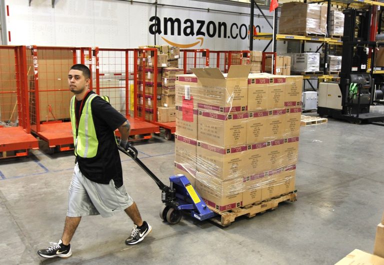 Humberto Manzano, Jr., delivers an arriving pallet of goods at an Amazon.com fulfillment center in Phoenix.  (AP Photo/Ross D. Franklin, file)