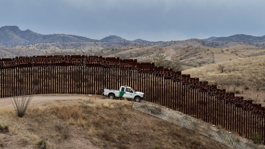 A Border Patrol officer guards the U.S.-Mexico border fence in Nogales, Ariz., in February. The Supreme Court on Friday said the Trump administration could continue with its plan to use military funds to build a wall along sections of the southern border. A Border Patrol officer guards the U.S.-Mexico border fence in Nogales, Ariz., in February. The Supreme Court on Friday said the Trump administration could continue with its plan to use military funds to build a wall along sections of the southern border. (Ariana Drehsler/AFP/Getty Images)