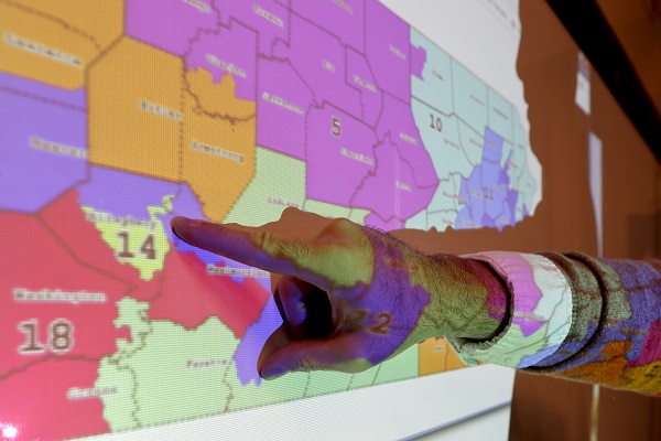 William Marx William Marx points out one of the districts that crossed four counties as an image of the old congressional districts of Pennsylvania are projected on a wall in the classroom where he teaches civics in Pittsburgh on Friday, Nov. 16, 2018. (Keith Srakocic/AP Photo)