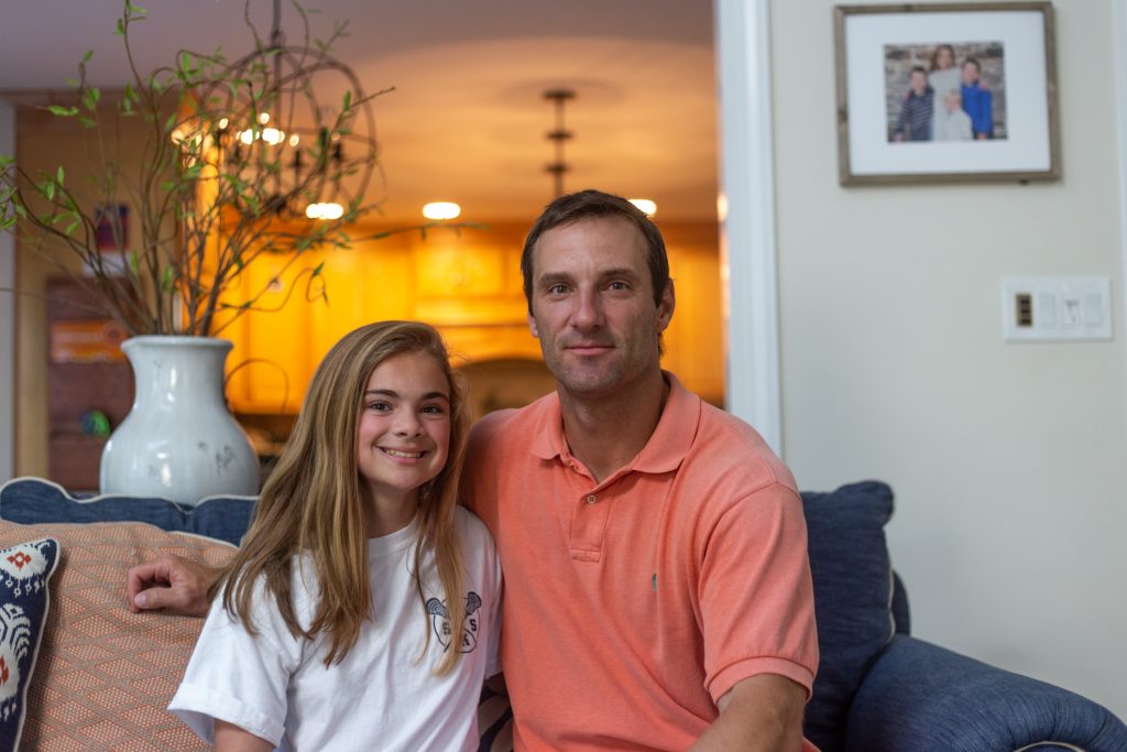 2019 06 27 – a gervasi – dimarino family – wayne -pediatric migraines2.jpg Lexi DiMarino and her father, Keith DiMarino, sit for a portrait in their Wayne, Pennsylvania home. Following a migraine that Lexi endured for 100 days in a row, the father-daughter pair have become outspoken advocates for pediatric migraine awareness. (Angela Gervasi for WHYY)
