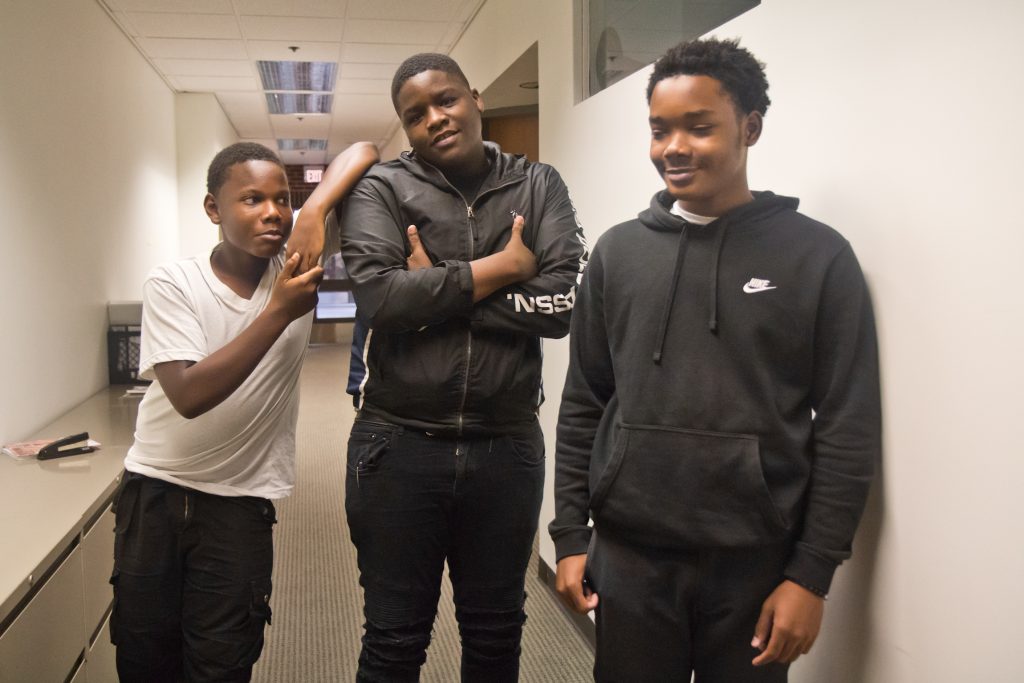 2019 07 23 k paynter phone biz teens Nasir Holloman (left), Kyree Keels (center) and Kadir Douglass (right) opened a phone repair business at their school. (Kimberly Paynter/WHYY)