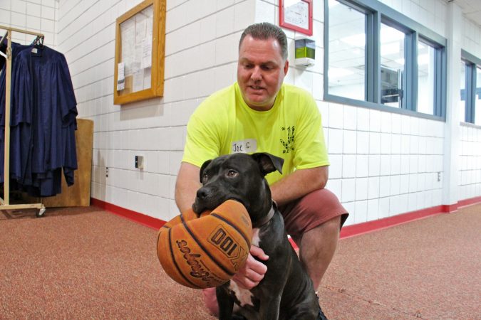 Joe S. created an animated video about his work with the inmate dog training program at Chester State Correctional Institution. He is shown with his trainee, Cas. (Emma Lee/WHYY)