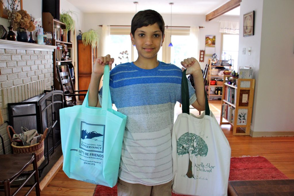 2019 08 15-e lee-kiran schatz-west chester-plastic bag ban Kiran Schatz, 12, carries his school supplies home in reusable bags. The West Chester student and his classmates worked to promote legislation that would ban the use of disposable plastic bags in their town. (Emma Lee/WHYY)