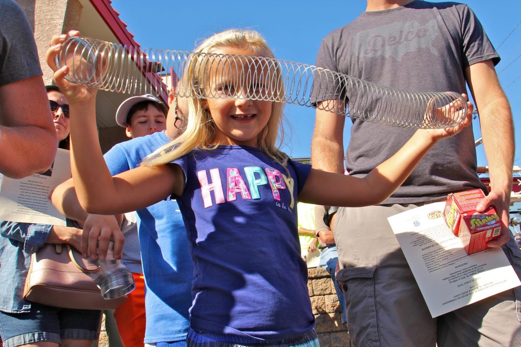 2019 08 30-e lee-clifton heights-slinky historical marker Maura McGlensey, 6, of Clifton Heights, plays with a Slinky during the dedication ceremony of a historical marker commemorating the manufacture of the popular toy at James Industries in Clifton Heights. (Emma Lee/WHYY)