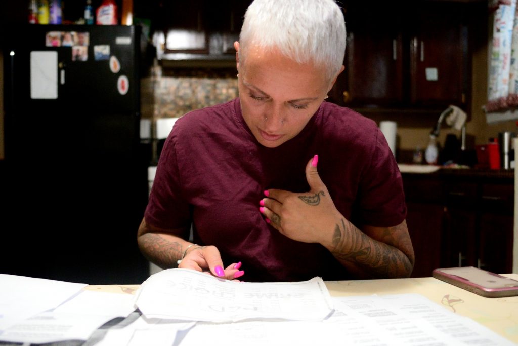 20190412_Broke_Dental_BS1577 At the kitchen table Summer Mills goes over documents accumulated in the past months while dealing with dental issues, on April 12, 2019. (Bastiaan Slabbers for WHYY)