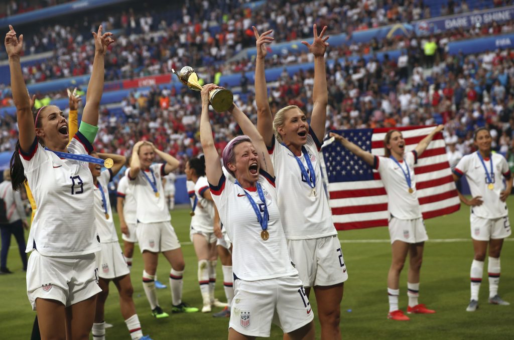 APTOPIX France US Netherlands WWCup Soccer United States' Megan Rapinoe, center, holds the trophy as she celebrates with teammates after they defeated the Netherlands 2-0 in the Women's World Cup final soccer match at the Stade de Lyon in Decines, outside Lyon, France, Sunday, July 7, 2019. (AP Photo/Francisco Seco)
