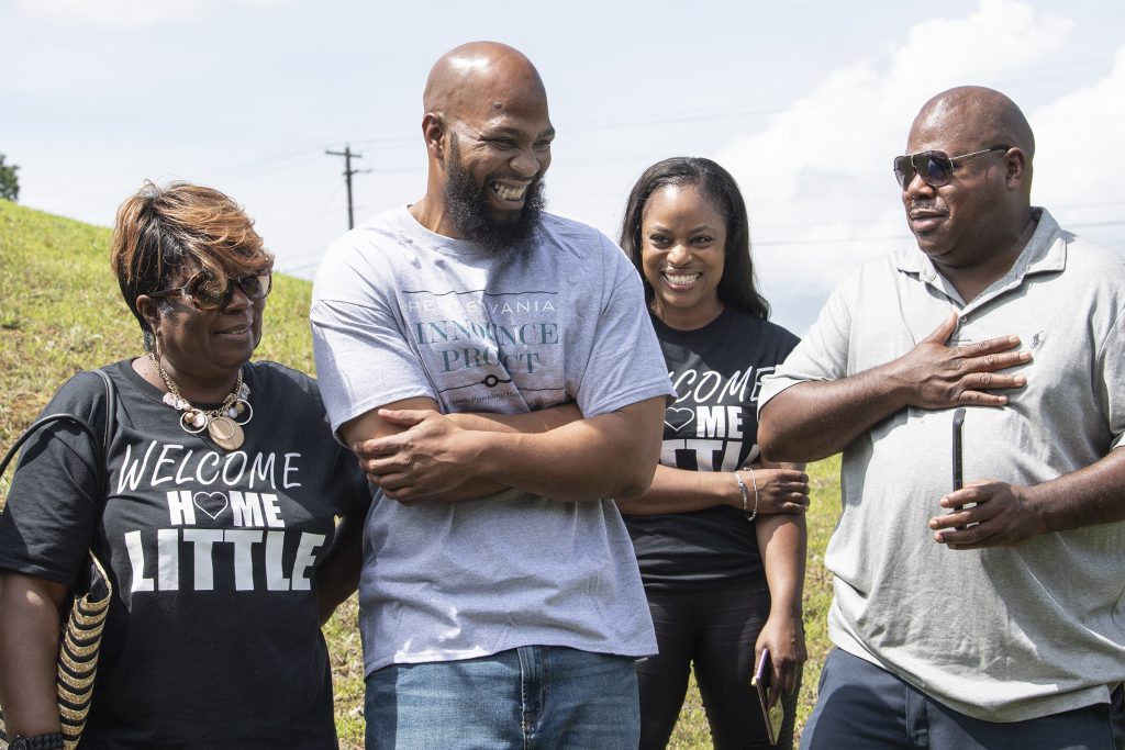 APTOPIX Exonerated After Decades John Miller, (center), smiles with his family, Velma Miller, (left), mother, Kalita Miller, sister, and brother Lamont Washington, outside the SCI Mahanoy State Correctional Institution in Frackville, Pa. Wednesday, July 31, 2019. Miller spent more than two decades behind bars for a murder he didn't commit, is a free man. (Jose F. Moreno/The Philadelphia Inquirer via AP)