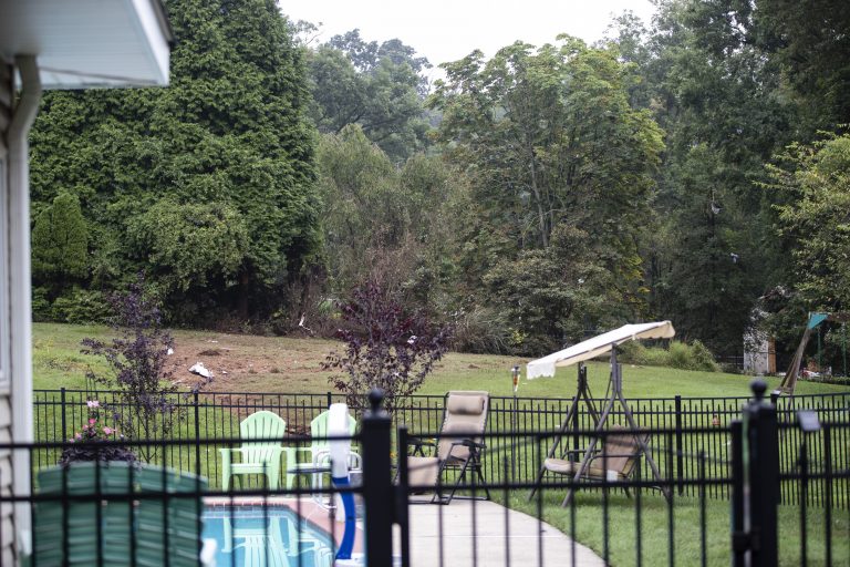 Debris from a small plane crash sets in backyards of a residential neighborhood in Upper Moreland, Pa., Thursday, Aug. 8, 2019.  Upper Moreland Police Chief Michael Murphy says the plane hit several trees before it finally came to rest. He said everyone aboard the plane was killed. (Matt Rourke/AP Photo)