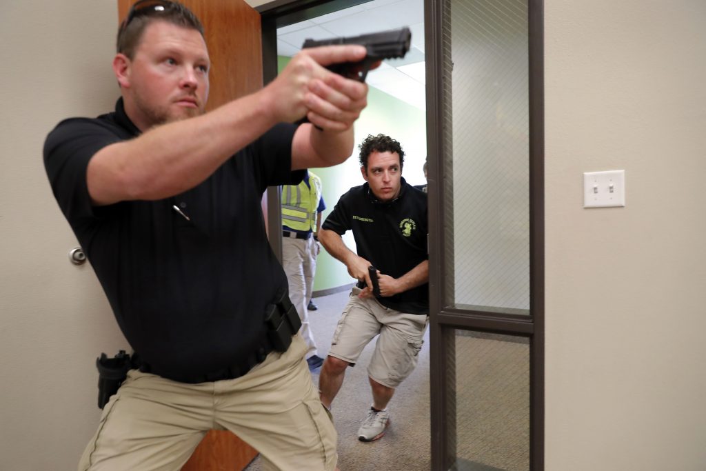 Churchgoers Security Training In this July 21, 2019 photo, Trainees Chris Graves, left, and Bryan Hetherington, right, participate in a security training session at Fellowship of the Parks campus in Haslet, Texas. (Tony Gutierrez/AP Photo)