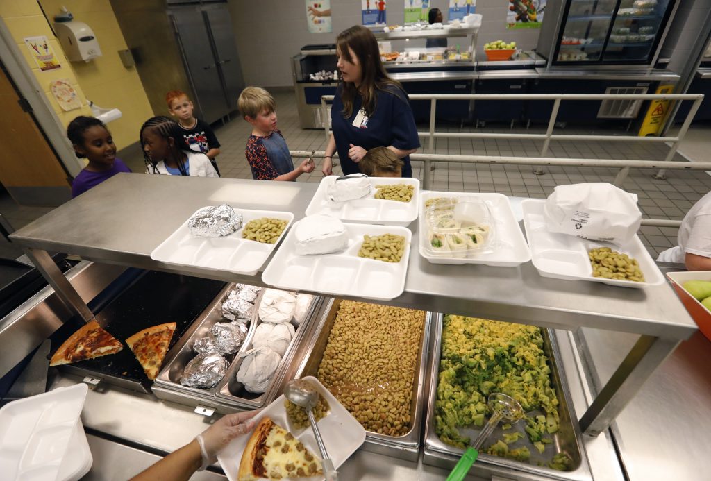 A teacher lines up the students for school-prepared lunches at Madison Crossing Elementary School in Canton, Miss., Friday, Aug. 9, 2019. Scott Clements, director of child nutrition at the Mississippi education department, said they've ordered two truckloads of trade mitigation pulled pork and four loads of kidney beans for use in their cafeterias. The products are coming from the U.S. Department of Agriculture, which is giving away the foods it’s buying to help farmers hurt by trade negotiations. (Rogelio V. Solis/AP Photo)