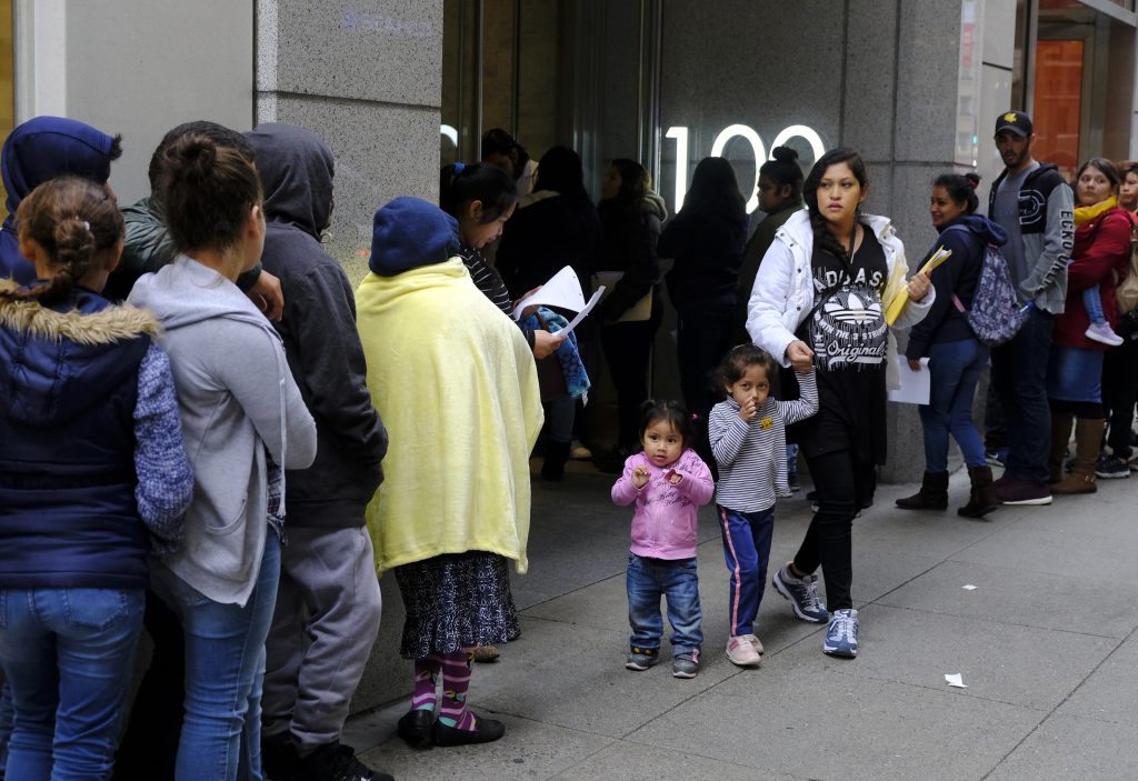 Immigration Public Benefits In this Jan. 31, 2019, file photo, hundreds of people overflow onto the sidewalk in a line snaking around the block outside a U.S. immigration office with numerous courtrooms in San Francisco. (Eric Risberg/AP Photo, File)