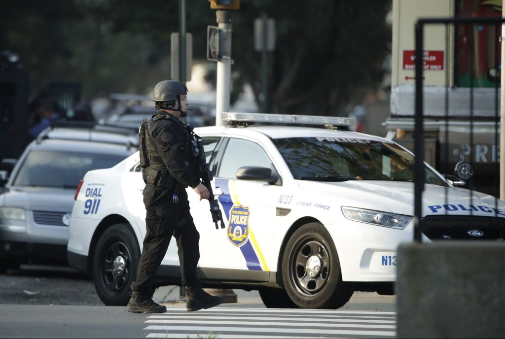 Gunman Firing at Police A police officer patrols the block near a house as they investigate an active shooting situation, Wednesday, Aug. 14, 2019, in the Nicetown neighborhood of Philadelphia. (AP Photo/Matt Rourke)