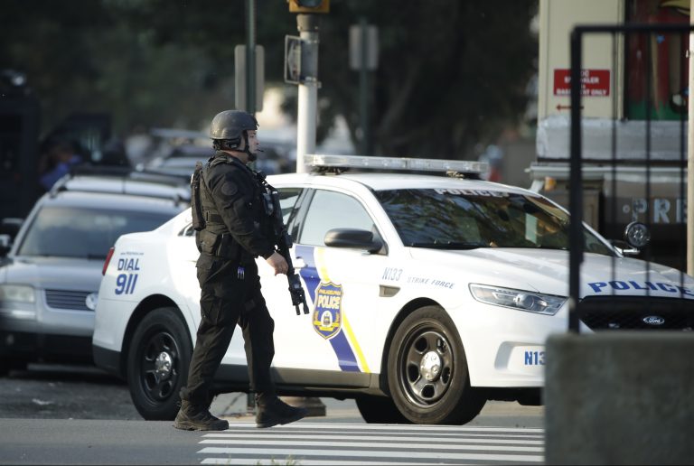 A police officer patrols the block near a house as they investigate an active shooting situation, Wednesday, Aug. 14, 2019, in the Nicetown neighborhood of Philadelphia. (AP Photo/Matt Rourke)