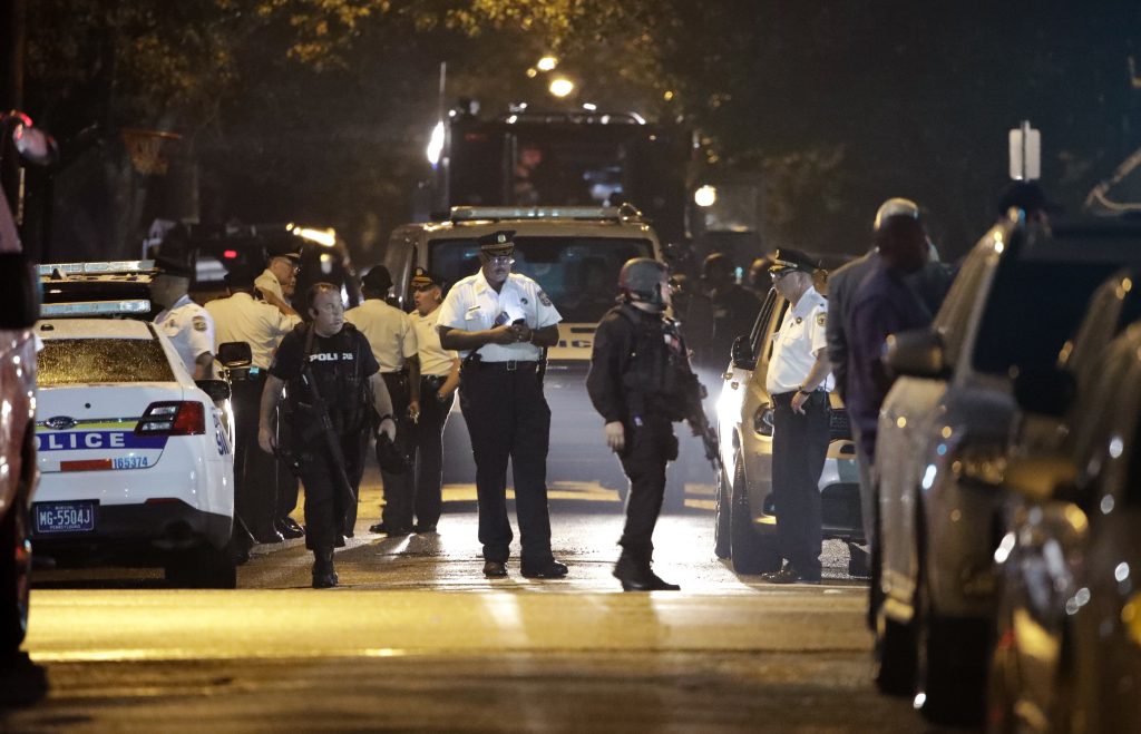 Philadelphia Gunman Standoff Police remain on the scene after a gunman was apprehended following a standoff Thursday, Aug. 15, 2019, in Philadelphia. A gunman who opened fire on police Wednesday as they were serving a drug warrant in Philadelphia, wounding several officers and triggering a standoff that extended into the night, is in police custody, authorities said. (AP Photo/Matt Rourke)