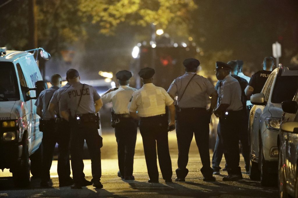 Philadelphia Gunman Standoff Policer officers watch as a gunman is apprehended following a standoff Wednesday, Aug. 14, 2019, in Philadelphia. (AP Photo/Matt Rourke)