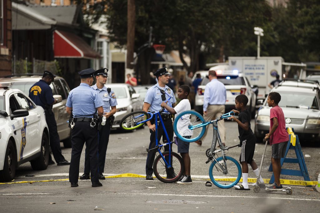 Philadelphia Gunman Standoff Children visit with officers as officials conduct an investigation at the scene of Wednesday's standoff with police in Philadelphia, Thursday, Aug. 15, 2019. The gunman, identified as Maurice Hill, wounded six police officers before surrendering early Thursday, after an hours-long standoff. (Matt Rourke/AP Photo)