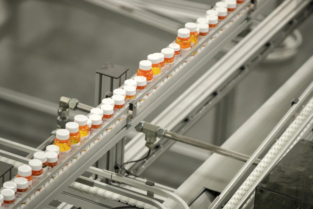 Drug Prices-Smaller Hikes FILE- In this July 10, 2018, file photo bottles of medicine ride on a belt at a mail-in pharmacy warehouse in Florence, N.J. Drug companies are still raising prices for brand-name prescription medicines, just not as often or by as much as they used to, according to an Associated Press analysis. (AP Photo/Julio Cortez, File)
