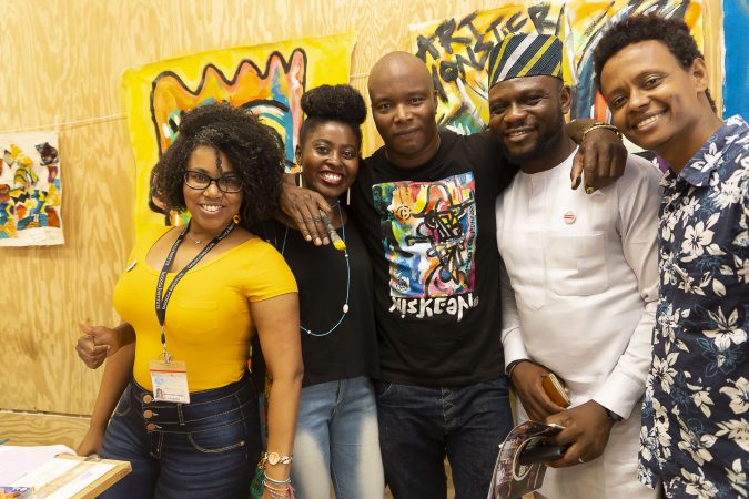 Chester Made Artistic Director Devon Walls (center) poses with Mandela Washington Fellows (from left to right), Janice Soraia Fortes Da Graca, Falecia Eliabu Massacky, Sunday Gift Unekwuojo Agbonika, and Desta Mekonen Abreha, in the Chester Made Makerspace during the Chester Made and Mandela Washington Fellowship Exchange 2019. (Greg Irvin)