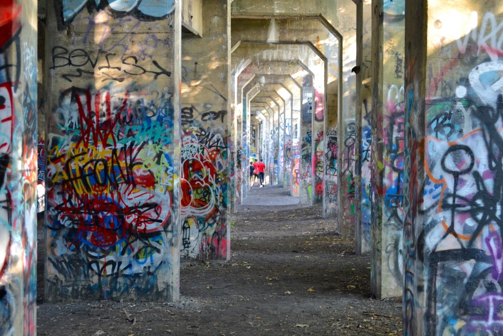 Visitors walk under the arches of Graffiti Pier. Joel Wolfram/for WHYY Visitors walk under the arches of Graffiti Pier. (Joel Wolfram for WHYY)