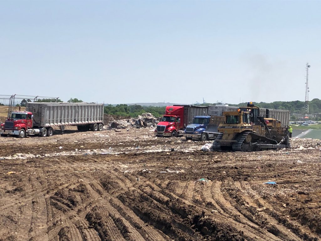 IMG_2890 (1) A view of trucks on a landfill