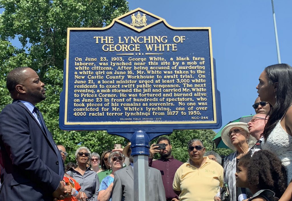 MARKER-UNVEILING-1crop Sen. Darius Brown, Savannah Shepherd and others read the words on The Lynching of George White Historical Marker just minutes after it was unveiled at Greenbank Park on June 23. (Scott Goss/Delaware Senate Majority Caucus)